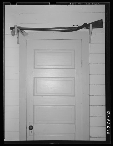 Shotgun over the door for sake of quick availability in farmer's home. Crowley, Louisiana