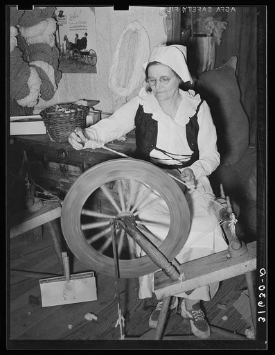 Madame Dronet spinning thread from carded cotton. Erath, Louisiana