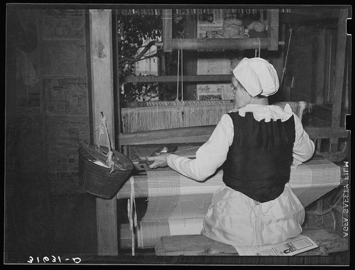 Madame Dronet using shuttle in weaving. Erath, Louisiana