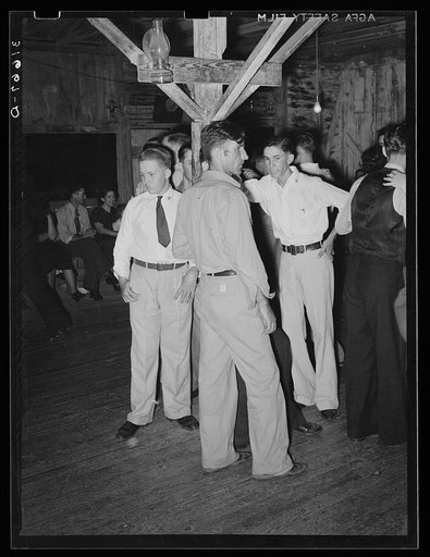 Fais-do-do dance. Cajun men congregate in center of hall. Near Crowley, Louisiana