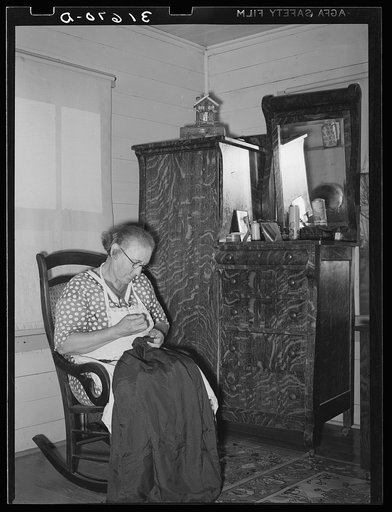 Cajun woman patching in corner of living room. Near Crowley, Louisiana