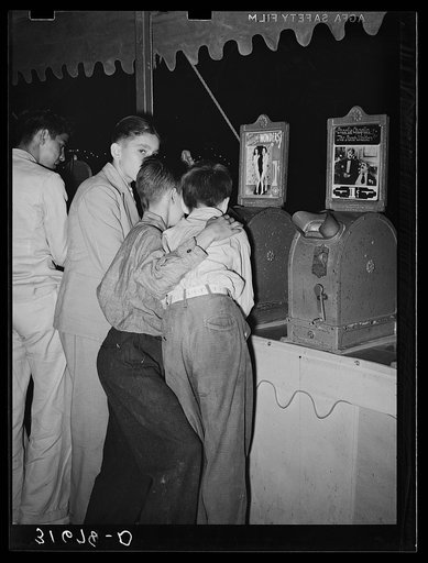 Boys looking at penny movies at South Louisiana State Fair. Donaldsonville, Louisiana