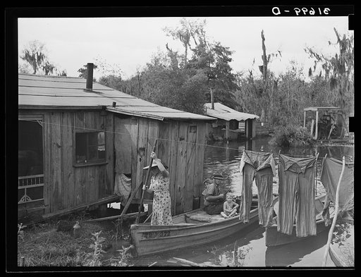 Fisherman's family returning from early morning's fishing near Akers, Louisiana