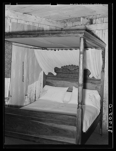 Four-poster bed with canopy and mosquito bar in home near Lutcher, Louisiana