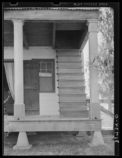 Detail of Acadian house with outside stairway leading to attic. Near Breaux Bridge, Louisiana