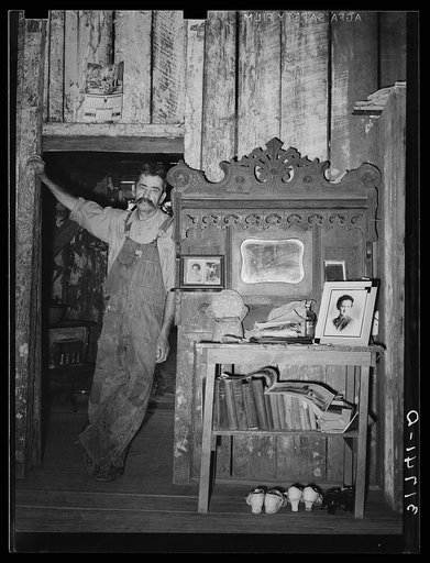 W.E. Smith, farmer near Morganza, Louisiana, in his home