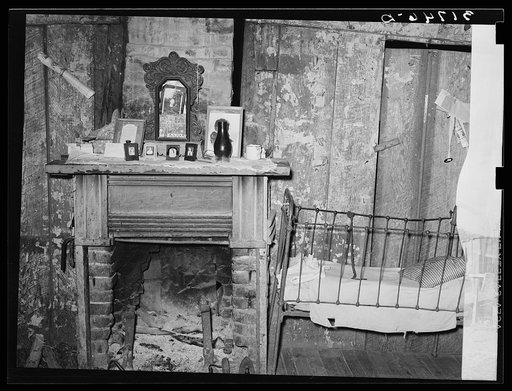 Fireplace and baby's crib in home of W.E. Smith, farmer near Morganza, Louisiana