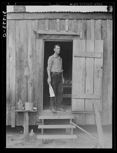 M. LaBlanc standing in doorway of present farm home. Morganza, Louisiana