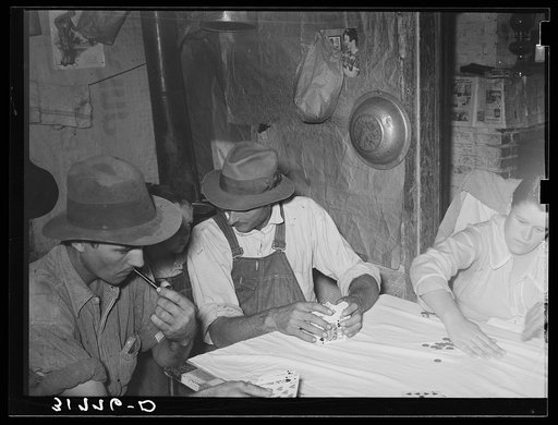 End of hand of poker played by day laborers at home near New Iberia, Louisiana