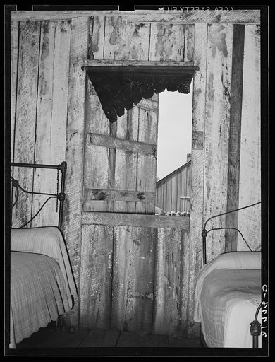 Detail of bedroom in house of Emil Kimball. Morganza, Louisiana. Note walls stained by rain. No screens or glass for window. Mr. Kimball is a tenant purchase client