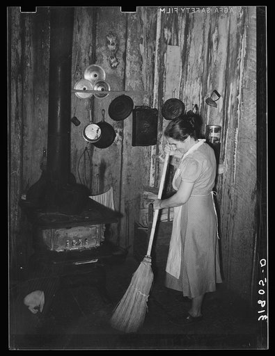 Mrs. Emil Kimball sweeping kitchen in her present home. The broom was made by Mr. Kimball. Morganza, Louisiana. They will participate in tenant purchase program
