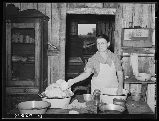 Untitled photo, possibly related to: Mrs. M. LaBlanc washing dishes in kitchen of her present home. Morganza, Louisiana
