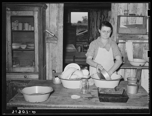 Mrs. M. LaBlanc washing dishes in kitchen of her present home. Morganza, Louisiana