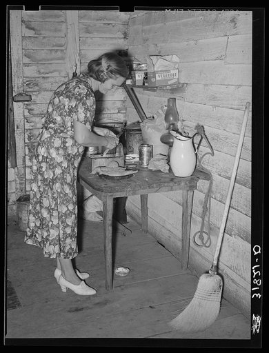 Mrs. Adams, wife of farmer near Morganza, Louisiana, preparing sweet potatoes for dinner. Family will shortly be helped by FSA (Farm Security Administration)