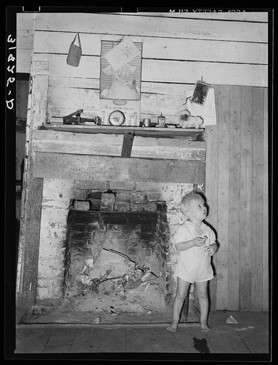 Hairlipped son of Adams family in front of fireplace. Morganza, Louisiana