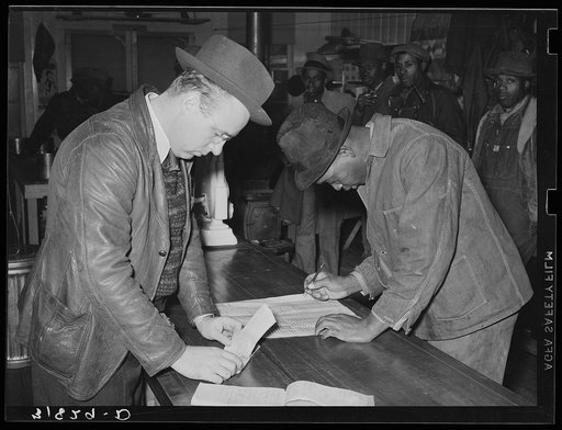 Negro member of Lakeview Cooperative Association receiving check from paymaster. Arkansas