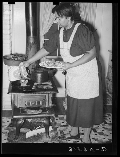 Farmer's wife cooking meat preparatory to canning. Lakeview Project, Arkansas