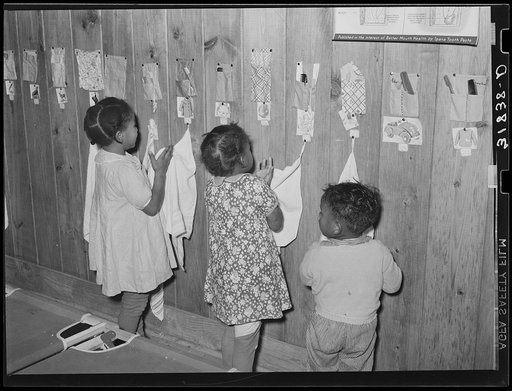 Child wiping hands after washing. Lakeview nursery school. Arkansas