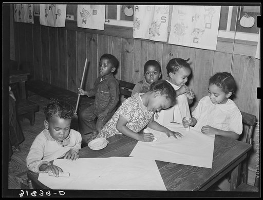 Negro children playing with chalk in nursery school. Lakeview Project, Arkansas