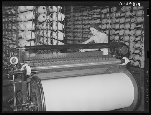 Winding machine, where large cylinders of warp are prepared for later use in weaving cloth. Laurel mills, Mississippi