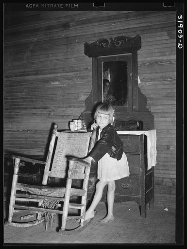 A child of Scarbrough's in front of dresser. Laurel, Mississippi