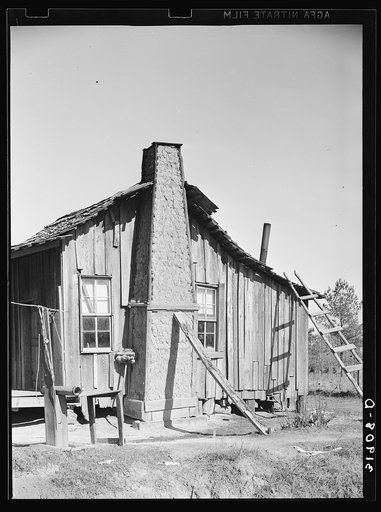 Untitled photo, possibly related to: Negro cabin, showing grass and mud chimney and broom made of corn husks for sweeping yard. Taylorsville, Mississippi
