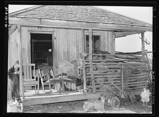 Goods stored on front porch of former sharecropper's cabin, now temporary home of FSA (Farm Security Administration) client. Transylvania, Louisiana