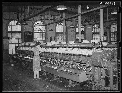 General view of machines where cotton thread is wound onto spools from spindles. Laurel mills, Laurel, Mississippi