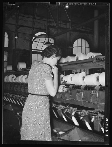 Operator of spool winding machine making knot. When spindles run out these knots are made with machine in her left hand. The small machine costs sixty-five dollars and replaces ten to fifteen operators. Laurel mills, Laurel, Mississippi