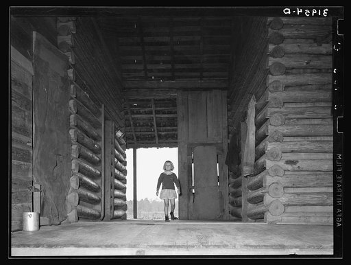 Child of Ed Baggett, sharecropper, walking through open space in dog trot cabin near Laurel, Mississippi