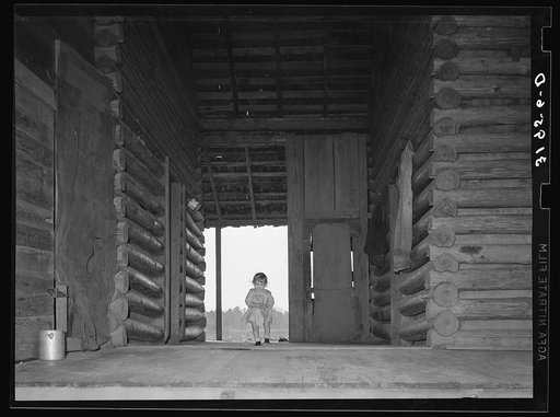 Untitled photo, possibly related to: Child of Ed Baggett, sharecropper, walking through open space in dog trot cabin near Laurel, Mississippi