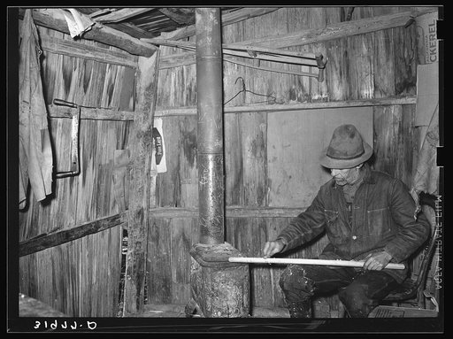 Mot Tucker making ax handles in living room of his corncrib home. Antioch, Mississippi