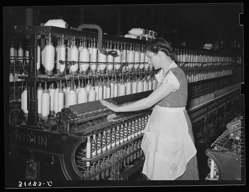 Operator of thread-making machine. Laurel cotton mill, Laurel, Mississippi