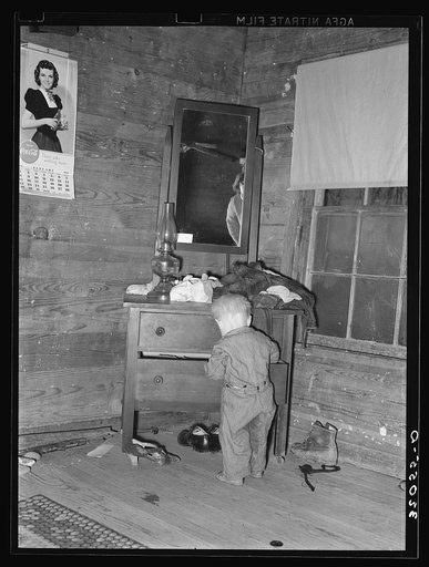 Pace (vicinity), Mississippi, in the Delta area. The corner of a tenant farm living room and bedroom. This family was moved to Sunflower plantation, a FSA (Farm Security Administration) project