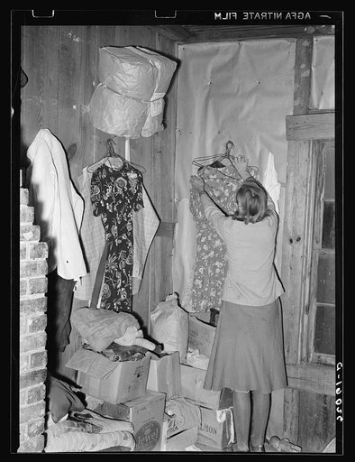 Goods piled in corner of living room of sharecropper near Merigold, Mississippi. Background photo, Sunflower Plantation