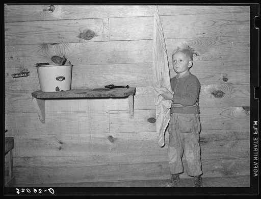 Son of tenant farmer washing hands. Near Pace, Mississippi. Background photo, Sunflower Plantation