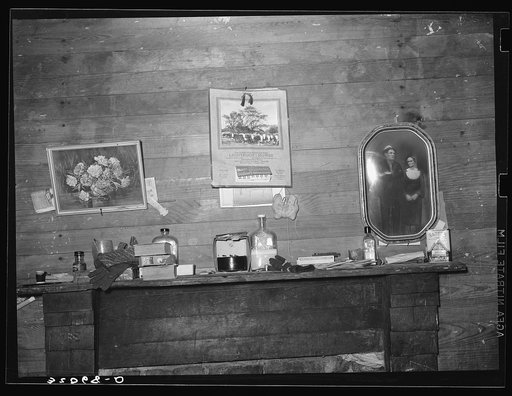 Decorations above mantelpiece in farm home near Merigold, Mississippi. Background photo for Sunflower Plantation