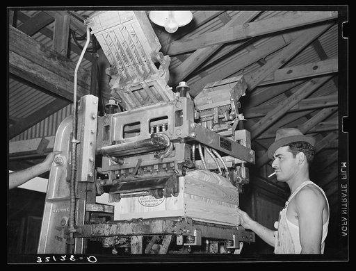 Lidding machine used in packing vegetables. Elsa, Texas