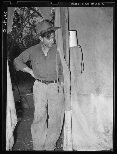 White migrant father standing in doorway of tent home near Harlingen, Texas. See 32108-D
