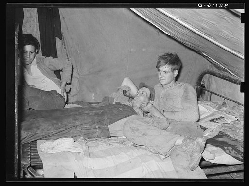 White migrant worker lying on bed in tent home near Mercedes, Texas. See 32108-D