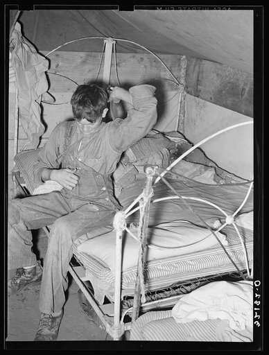 Son of white migrant worker putting on overalls in tent near Harlingen, Texas. See 32108-D