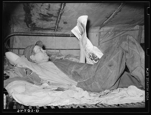 Migrant worker on bed in tent home. Mercedes, Texas. See 32108-D