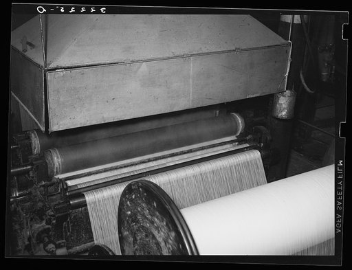 Saturating cotton thread with sweet potato starch at cotton mill. Laurel, Mississippi