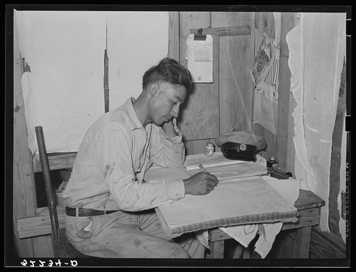 Mexican labor contractor working on his books. Robstown, Texas