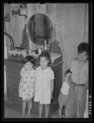 Untitled photo, possibly related to: Children of Mexican labor contractor in their home. Robstown, Texas. Note the shrine above the children. These shrines, many quite primitive, are found in practically all Mexican homes