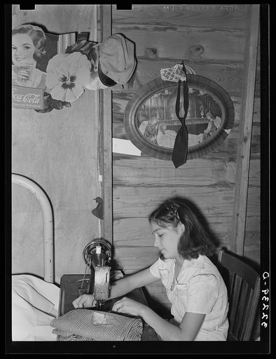 Mexican girl sewing in their home. Robstown, Texas. Contrary to the prevalent idea, Mexicans generally are extremely neat and clean even when they live in most crowded conditions