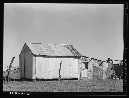 Mexican house, Robstown, Texas. Notice absence of windows. House is constructed of three materials: wood, tin and mud