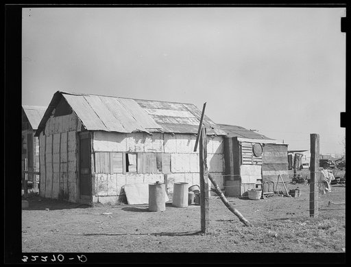 Mexican house made of scrap material. Notice the discarded tin ceiling material. Robstown, Texas