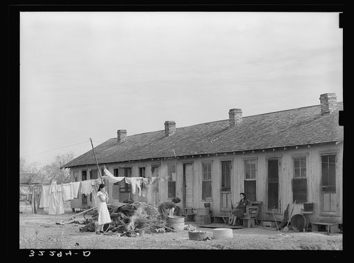Mexican migrant housing. Edcouch, Texas. These units are owned by a labor contractor who rents them for a nominal sum to his group of workers. They remain in the lower valley working in the vegetable and citrus fields for about nine months of the year. The contractor takes them in trucks to west Tex