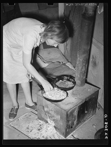 White migrant woman cooking cabbage in tent home. Edinburg, Texas